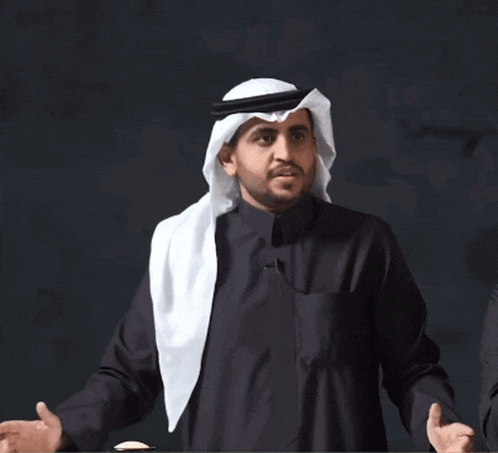 a man in a black shirt and a white head scarf