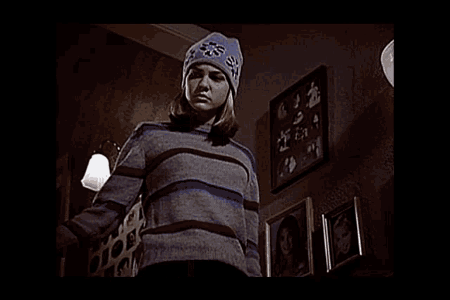 a person sitting on a set of stairs with a blanket over their head .