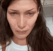 a close up of a woman 's face with tears running down her face .
