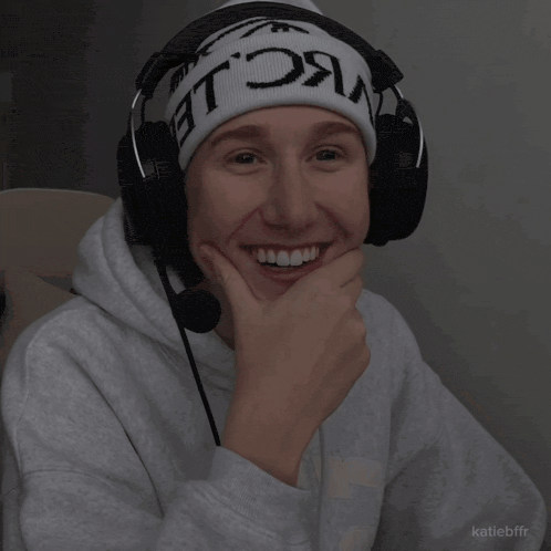 a person wearing headphones and a beanie that says ' nc le ' on it