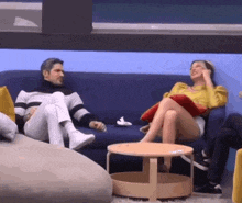 a man and a woman are sitting on a couch in a living room