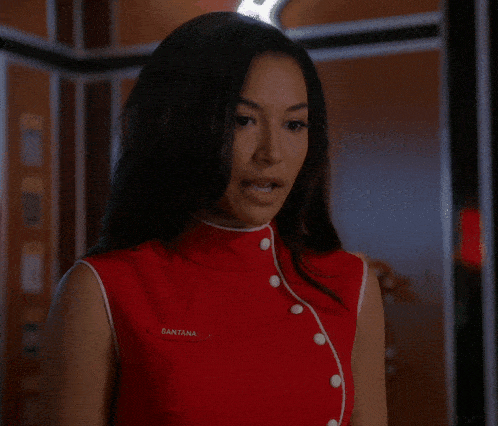 a woman wearing a red shirt with santana written on the sleeve