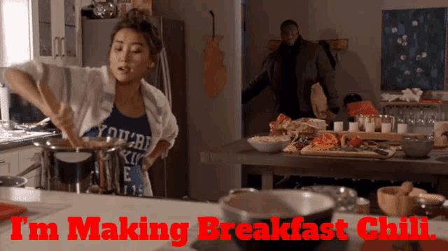 a woman cooking in a kitchen with the words i 'm making breakfast chili written above her