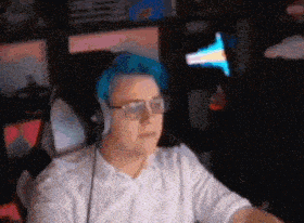 a man wearing glasses and headphones is sitting in front of a computer .