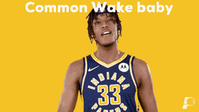 a man in an indiana pacers jersey flexes his arm