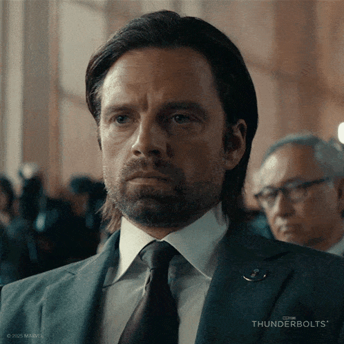 a man in a suit and tie with thunderbolts written on the bottom of the image