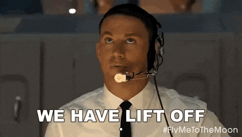 a man in a suit and tie is wearing a headset .