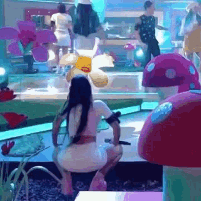 a woman in a white dress is squatting down in front of mushrooms