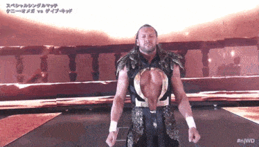 a wrestler in a black and gold outfit with the hashtag #njwd on the bottom left