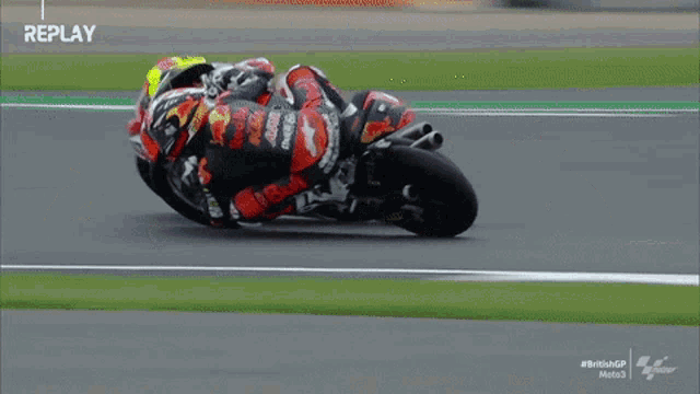 a man is riding a motorcycle on a track with the words replay at the bottom