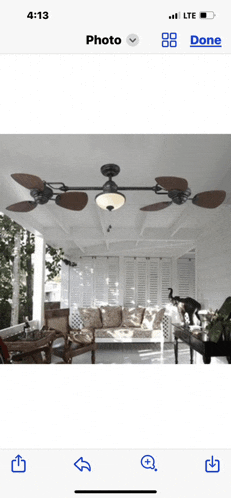 a phone screen shows a picture of a ceiling fan