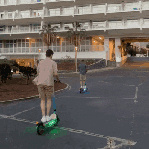 a man riding a green scooter in front of a building