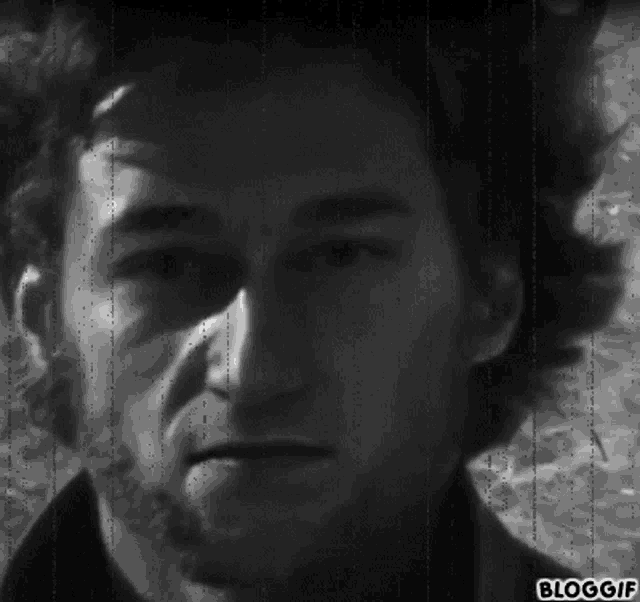 a black and white photo of a man 's face with the words bloggif on the bottom right