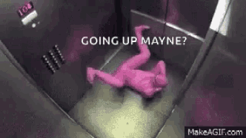 a person in a pink bodysuit is laying on the floor in an elevator .