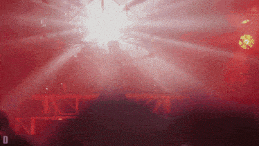 a blurred image of a stage with the letter d on the bottom right