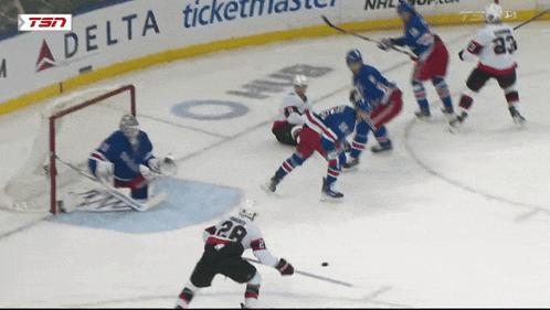 a hockey game is being played in front of a delta ticketmaster sign
