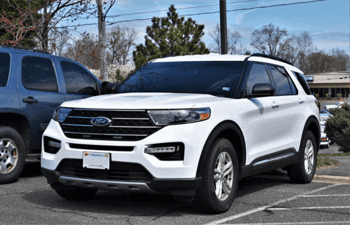 a white ford suv with a virginia license plate is parked in a parking lot