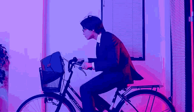 a man in a suit and tie is riding a bicycle with a basket that says fuji