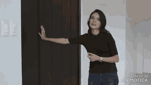 a woman standing in an empty room with the words made in animatica on the bottom right