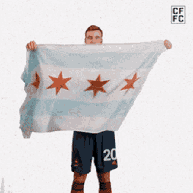 a man in shorts with the number 20 holds a chicago flag