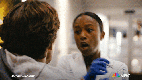 a woman in a lab coat is talking to a man in a chicagomed ad