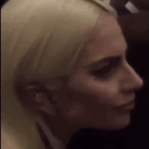 a close up of a woman 's face with ear buds in her ears
