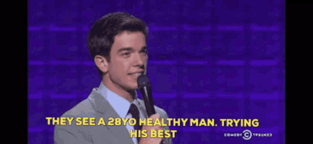 a man stands in front of a microphone and says they see a 28yo healthy man