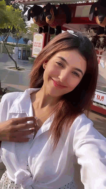 a woman taking a selfie in front of a sign that says ya19
