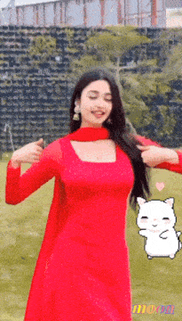 a woman in a red dress is dancing in front of a wall with the word moon on it