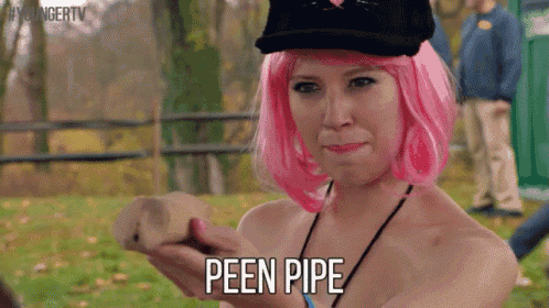 a woman in a pink wig is holding a piece of wood and saying peen pipe