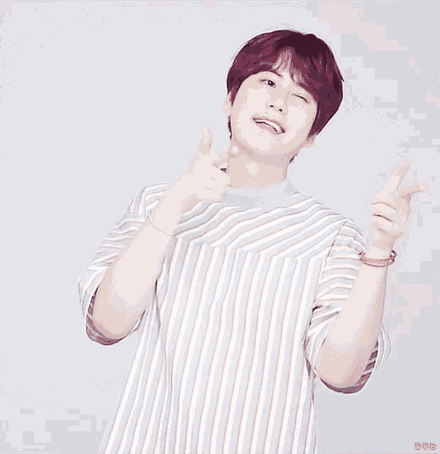 a man with red hair is wearing a striped shirt