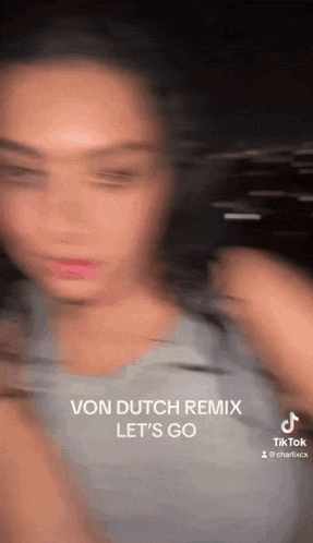 a blurry picture of a woman with the words `` von dutch remix let 's go '' written on the bottom .