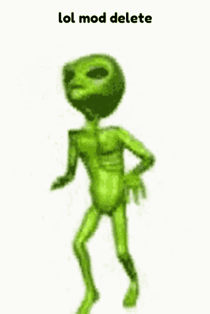 a green alien is talking on a cell phone while walking .