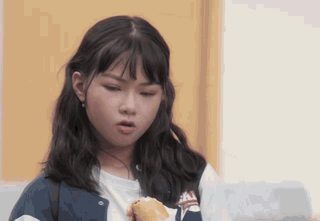 a girl wearing a jacket that says ' sai ' on the front