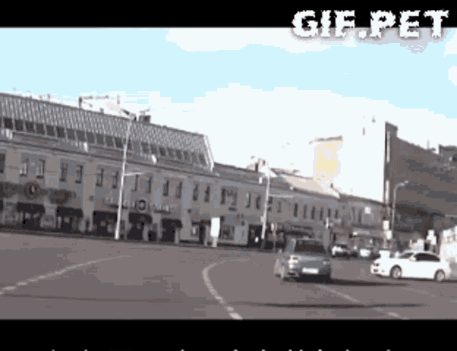a gif of a car driving down a street with the words gif.pet at the top