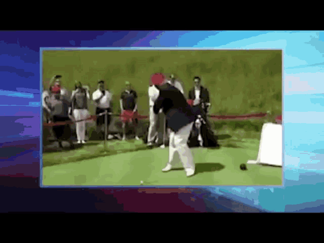a man is swinging a golf club at a golf ball