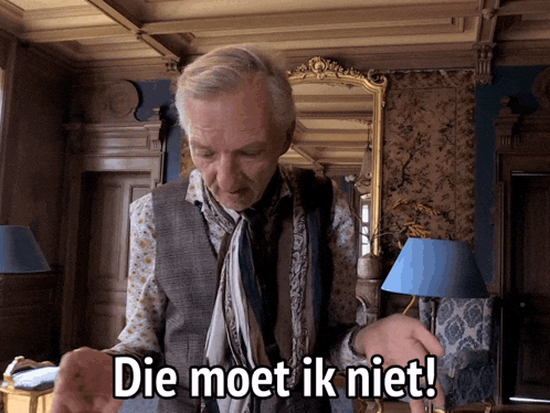 a man with a scarf around his neck stands in front of a mirror with the words die moet ik niet below him