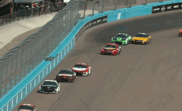 a row of race cars with one that says paypal on it