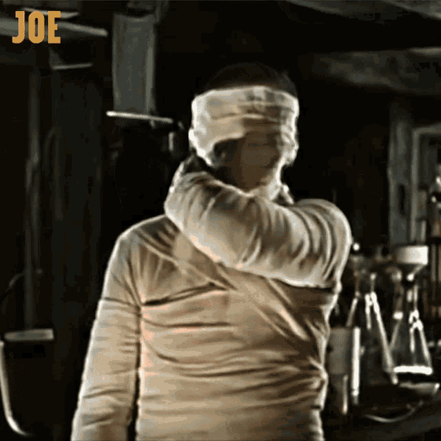 a man in a mummy costume has the word joe on the bottom right