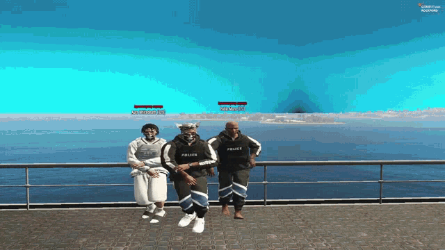 a group of people are standing on a pier and one of them is wearing a police hoodie