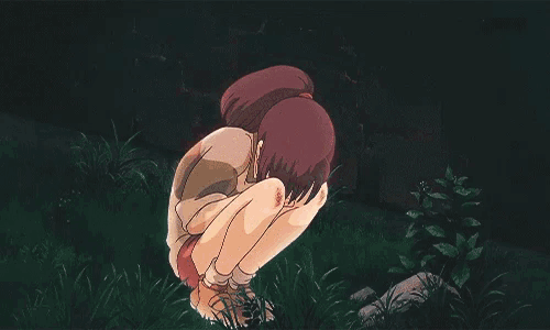 a woman is holding a man 's head in her arms