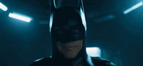 a close up of a man wearing a batman costume