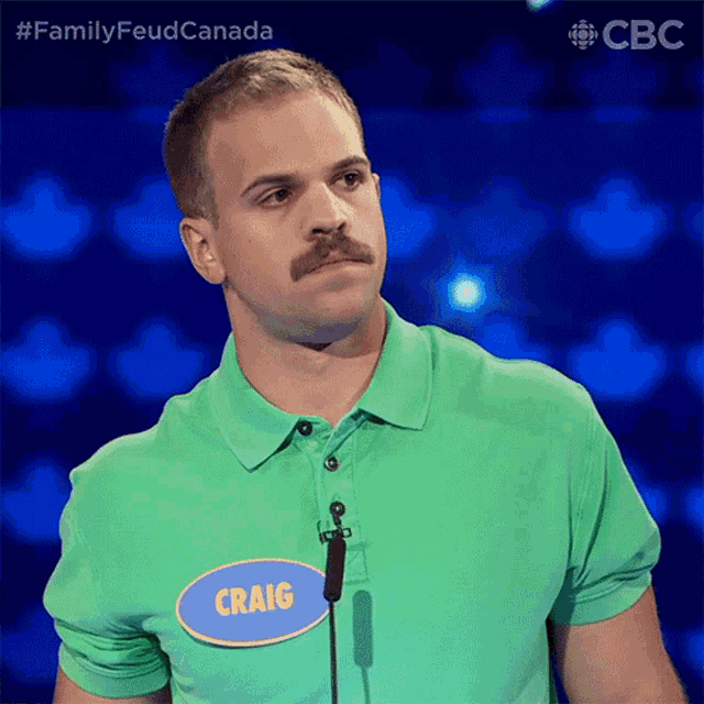 a man with a mustache is wearing a green shirt with a name tag that says craig