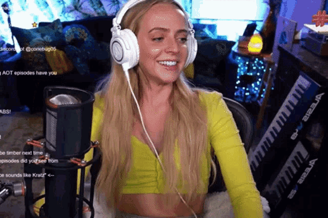 a woman wearing headphones is sitting in front of a microphone ..