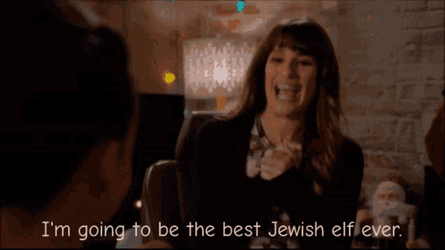 a woman is laughing and says i 'm going to be the best jewish elf ever
