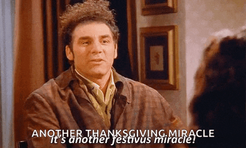a man is sitting at a table talking to a woman and saying another thanksgiving miracle
