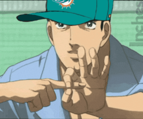 a man wearing a miami dolphins hat is pointing