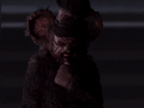 a scary clown with a top hat and gloves