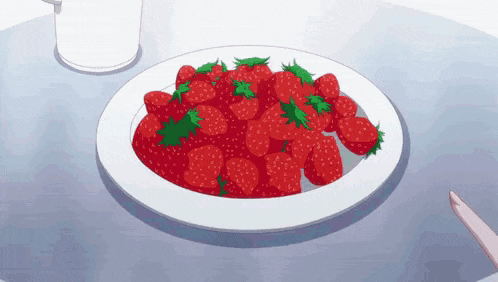 a white plate topped with strawberries on a table next to a glass of milk .