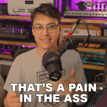 a man in front of a microphone with the words that 's a pain in the ass on the bottom